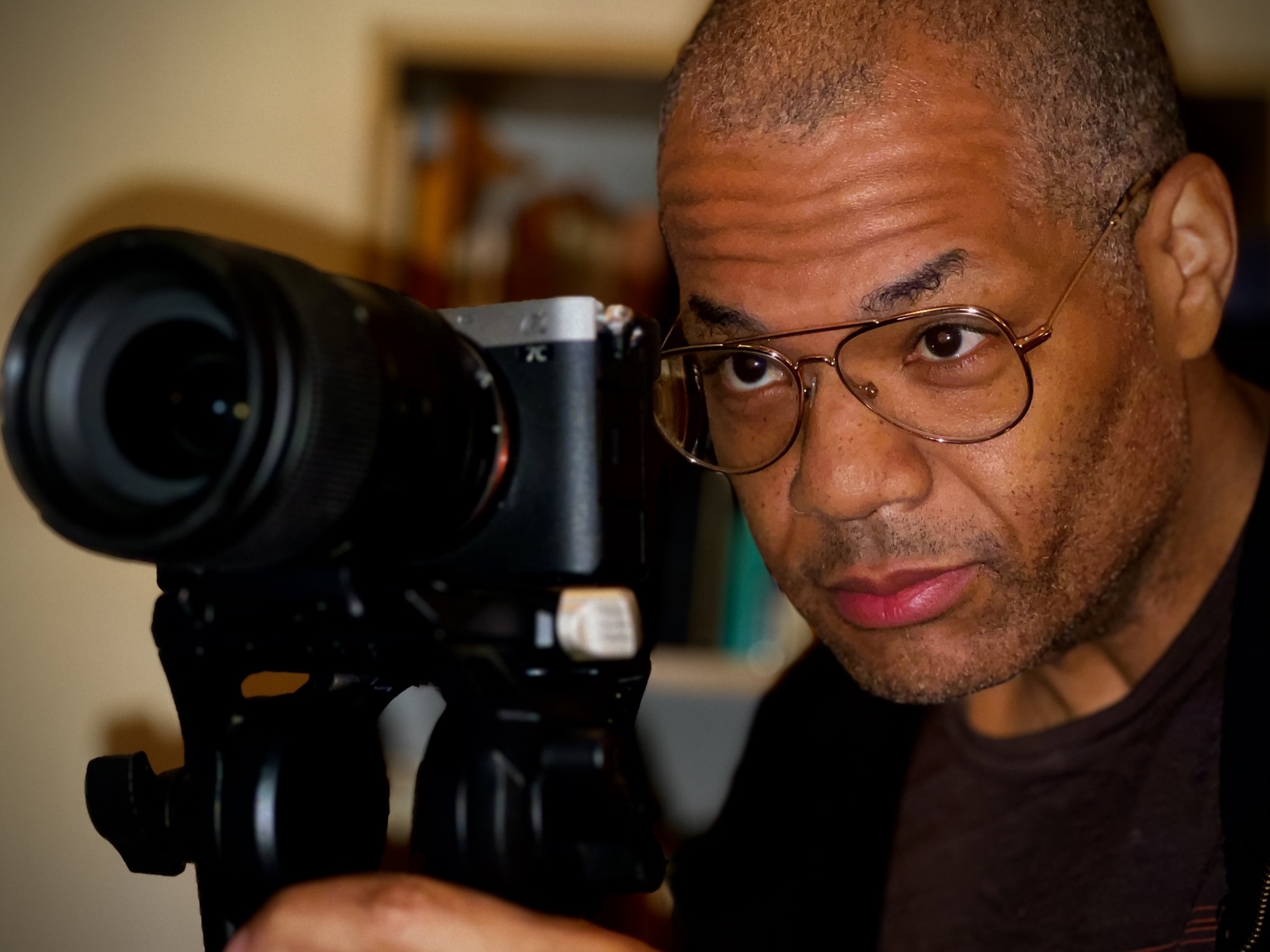 Chris Hardy looking through a camera viewfinder