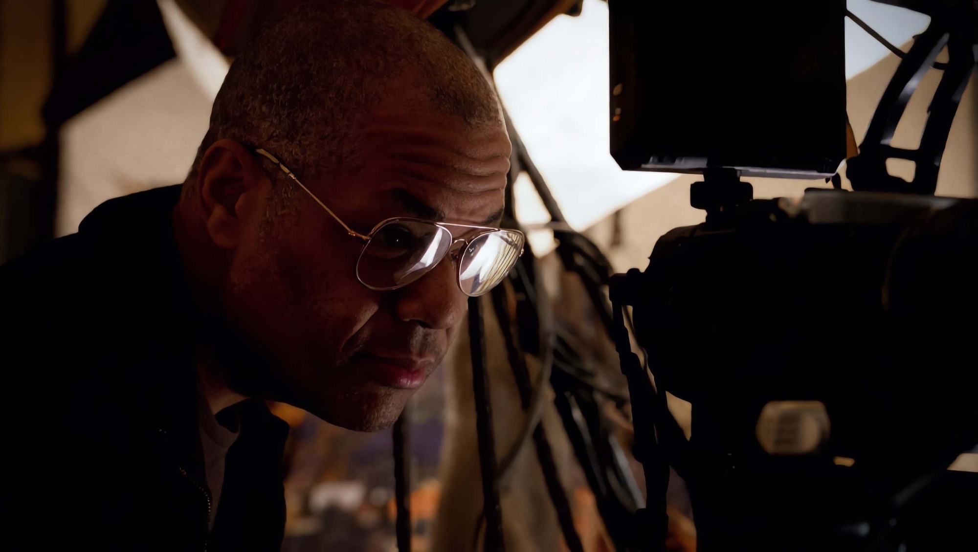 Chris Hardy checking a camera monitor on set